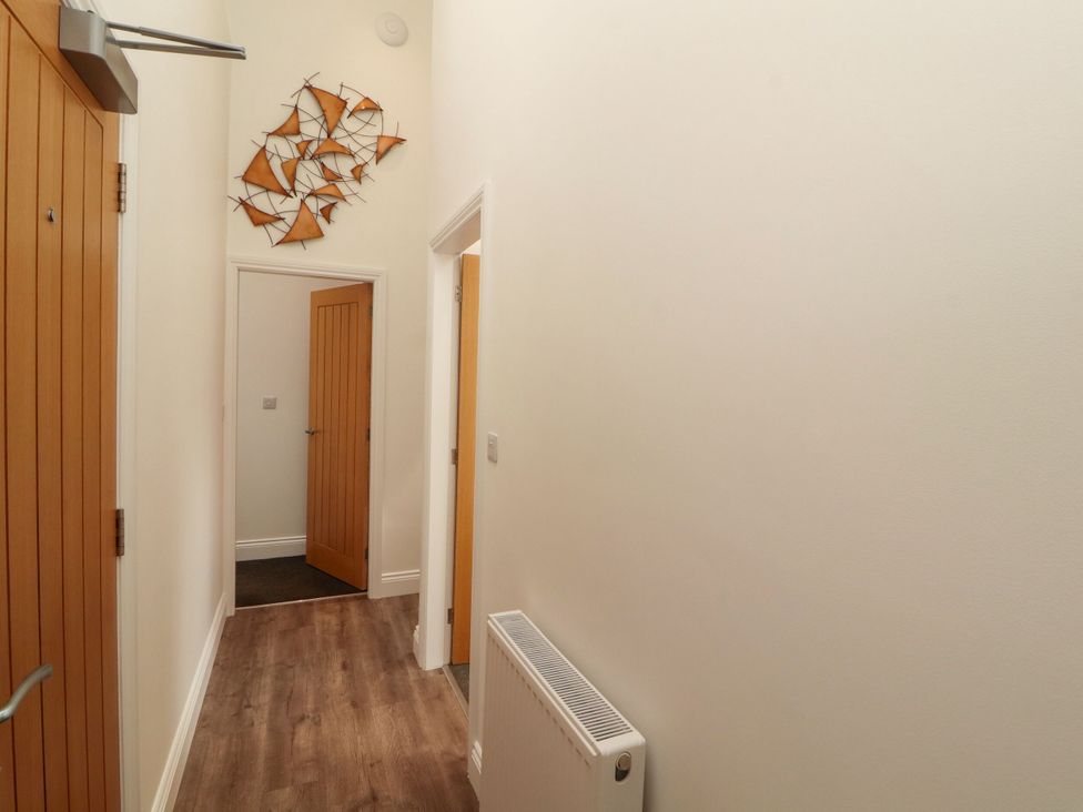 A hallway with doors and a radiator at Flat 3 in Carnforth