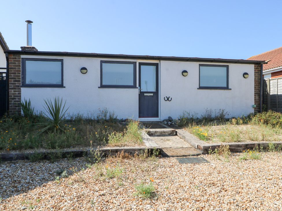 An outdoor view of a property with plants and a pathway at Harbour Road Quirky Beach Railway Carriages, Pagham
