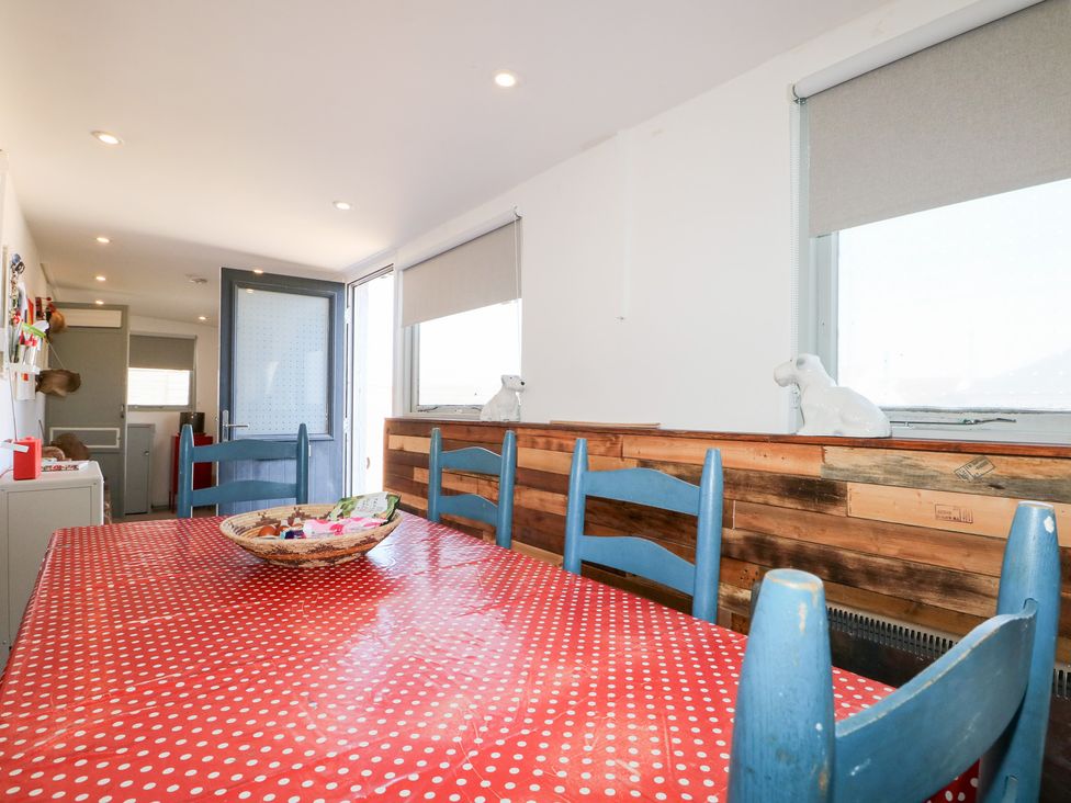 A dining room with a table and chairs at Harbour Road Quirky Beach Railway Carriages in Pagham