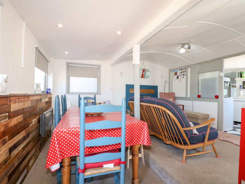 A living room with a dining area and seating at Harbour Road Quirky Beach Railway Carriages in Pagham