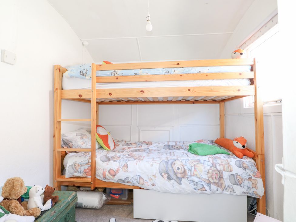 A bedroom with a bunk bed and stuffed animals at Harbour Road Quirky Beach Railway Carriages in Pagham