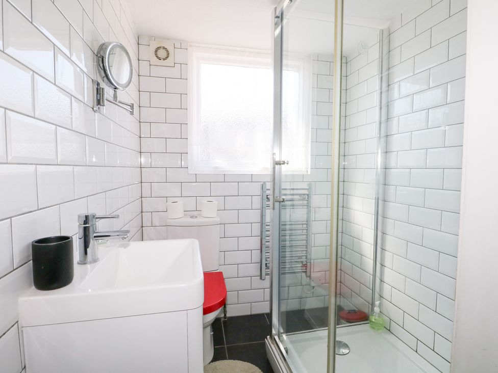 A bathroom with shower, sink and toilet at Harbour Road Quirky Beach Railway Carriages Pagham