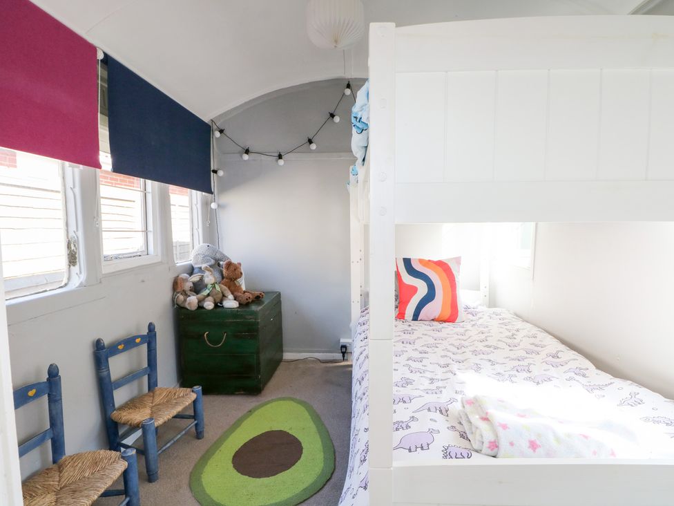 A bedroom with a bunk bed and stuffed animals at Harbour Road Quirky Beach Railway Carriages Pagham