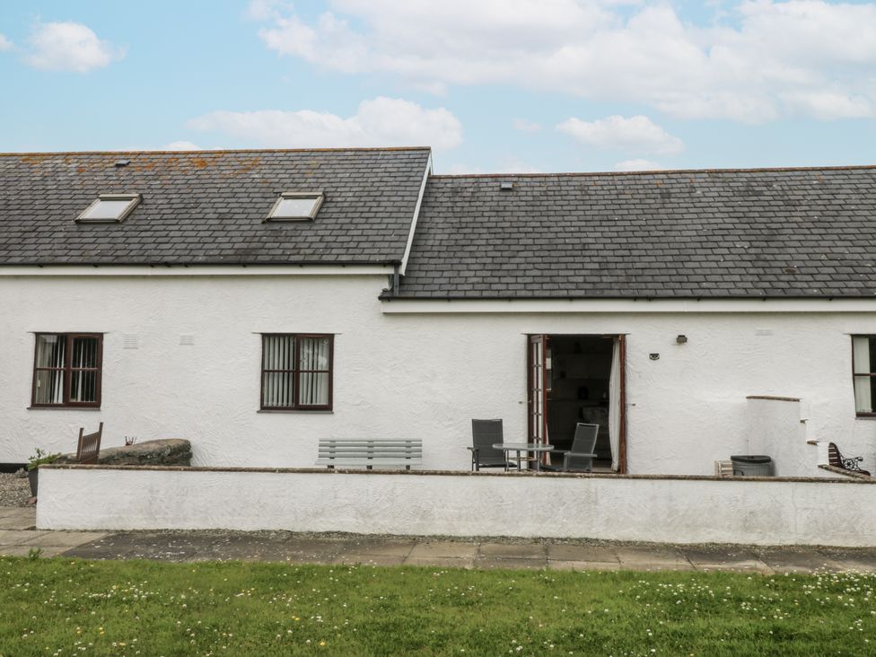 A house with garden and patio furniture at Florence Cottage in Holyhead