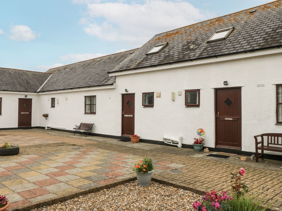 An outdoor area with buildings and benches at Florence Cottage in Holyhead
