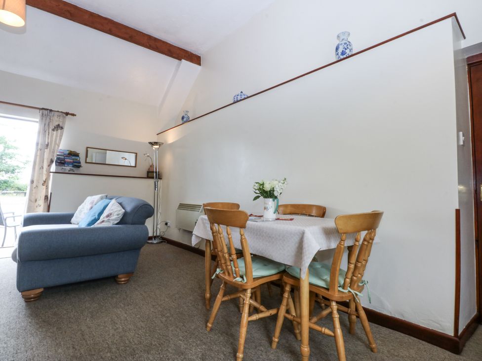 A dining area with a table and chairs in Florence Cottage Holyhead
