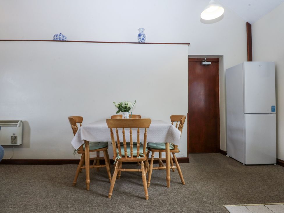 A dining room with a table and chairs at Florence Cottage in Holyhead