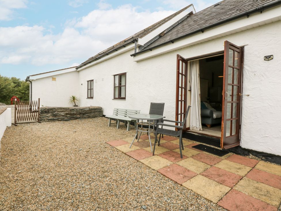 An outdoor area with a table and chairs at Florence Cottage in Holyhead