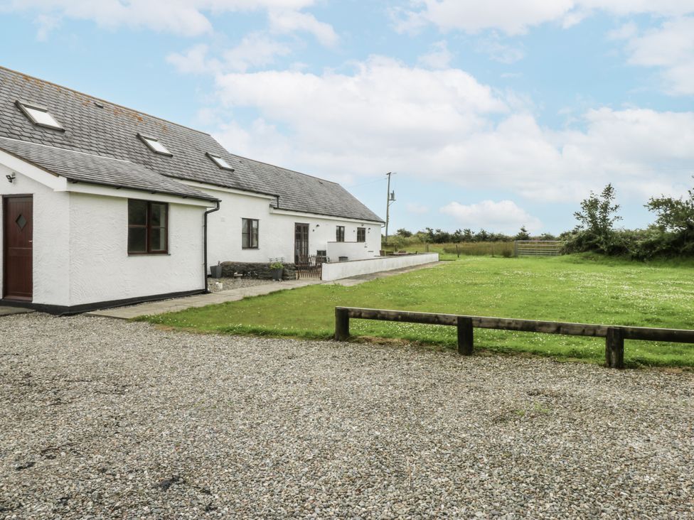 A house with lawn and gravel driveway at Florence Cottage Holyhead