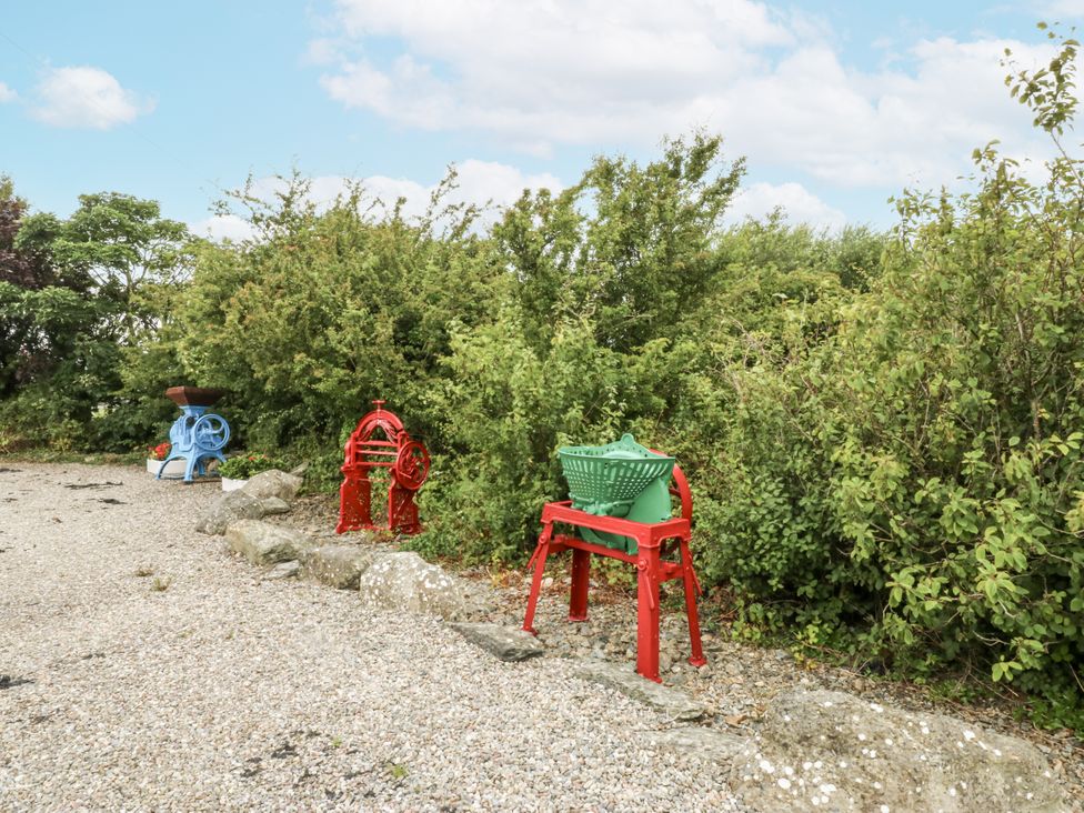A outdoor area with colorful equipment and chairs at Florence Cottage in Holyhead
