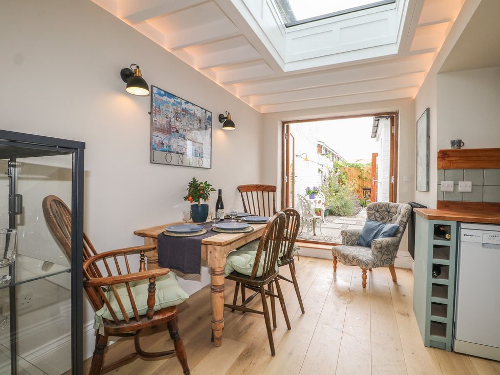 A dining room with a table and chairs at Lower Floor Flat in 