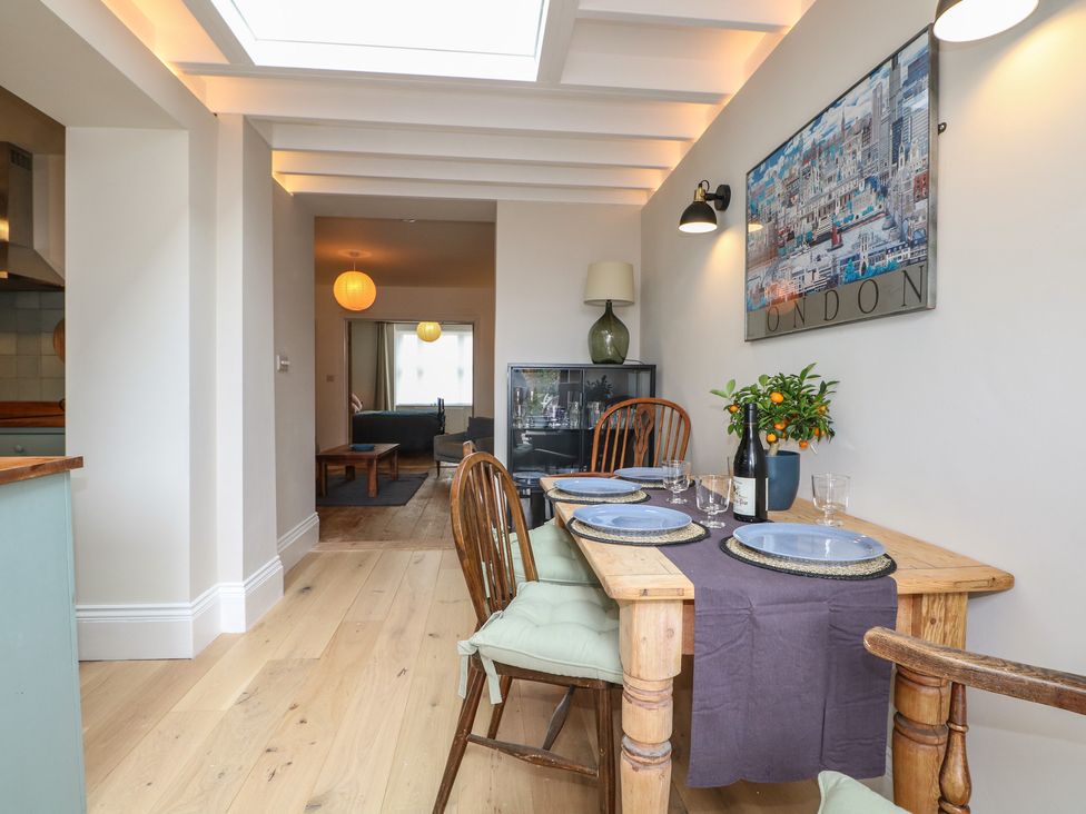 A dining room with a table set for meals at Lower Floor Flat