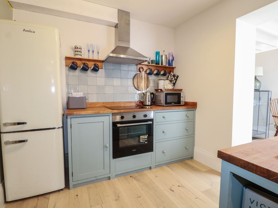 A kitchen with appliances and countertop at Lower Floor Flat in 