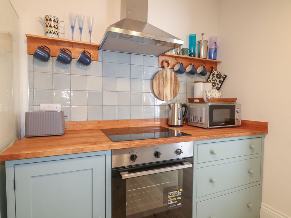 A kitchen with appliances and utensils at Lower Floor Flat