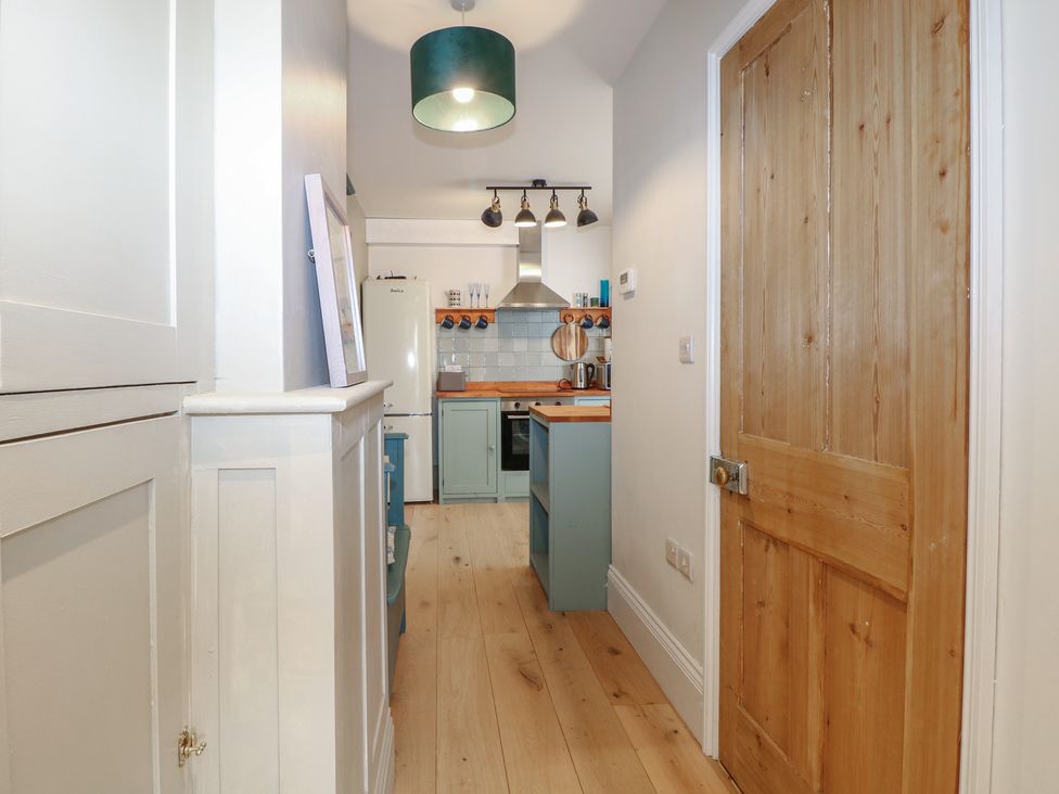 A kitchen with cabinets and a stove at Lower Floor Flat