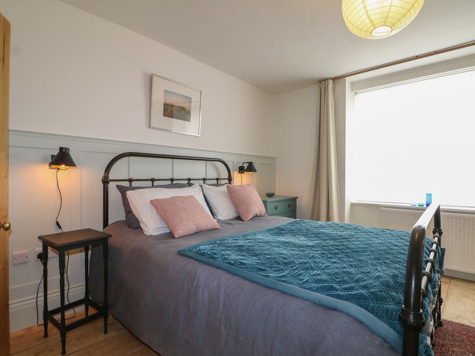 A bedroom with a bed and bedside table at Lower Floor Flat in 