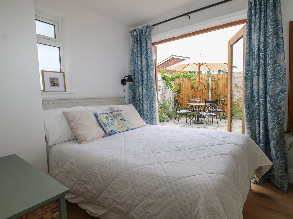 A bedroom with a bed and patio access at Lower Floor Flat 