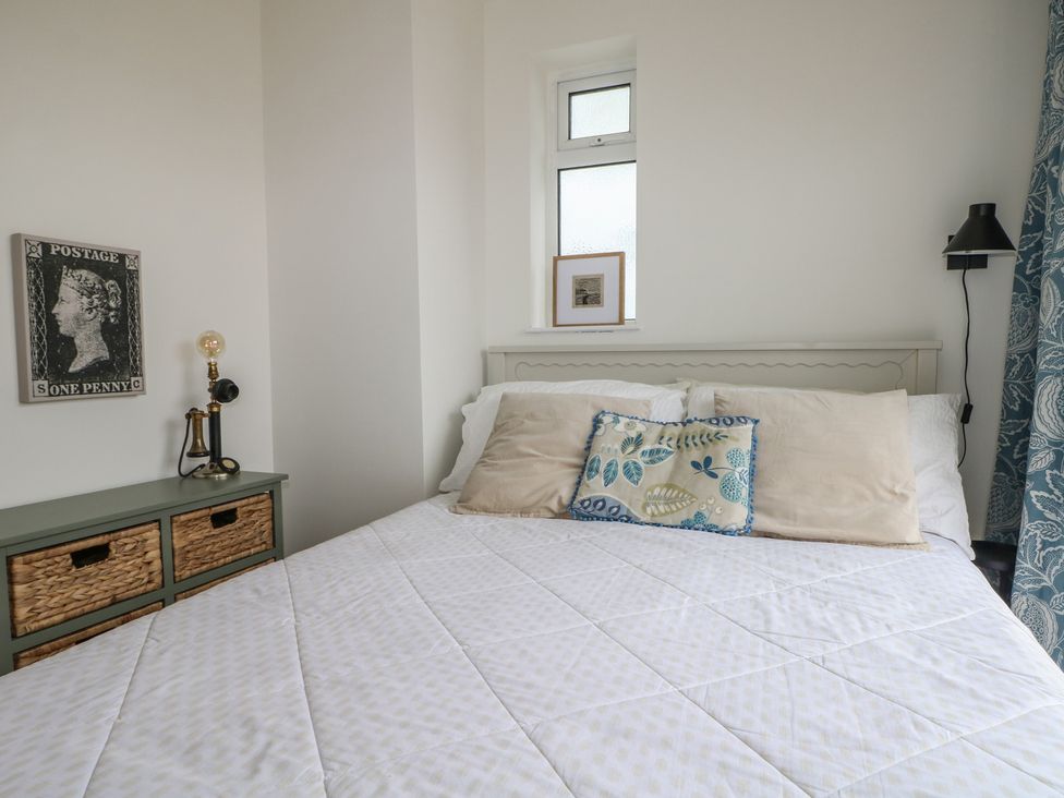 A bedroom with a bed and decorative items at Lower Floor Flat