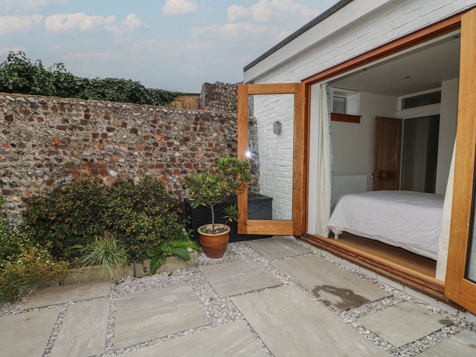 An outdoor area with a patio leading to a bedroom at Lower Floor Flat