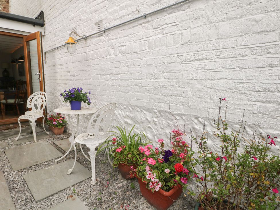 An outdoor area with a table and chairs at Lower Floor Flat