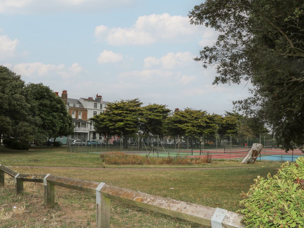 An outdoor view of tennis courts and trees at Lower Floor Flat