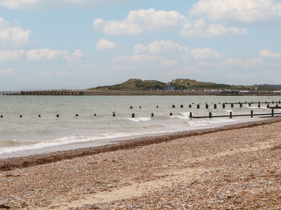 A beach view with a pier and sea at Lower Floor Flat in 