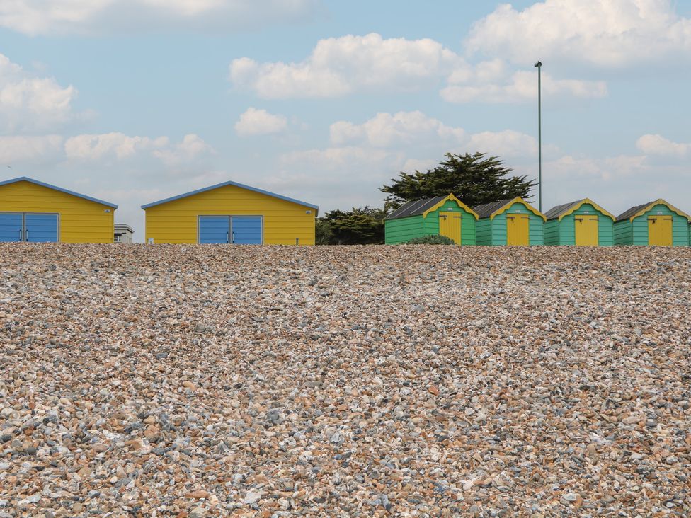 Colorful beach huts and gravel at Lower Floor Flat in 