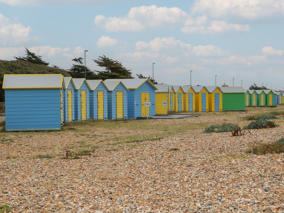 Beach huts along the shore at Lower Floor Flat