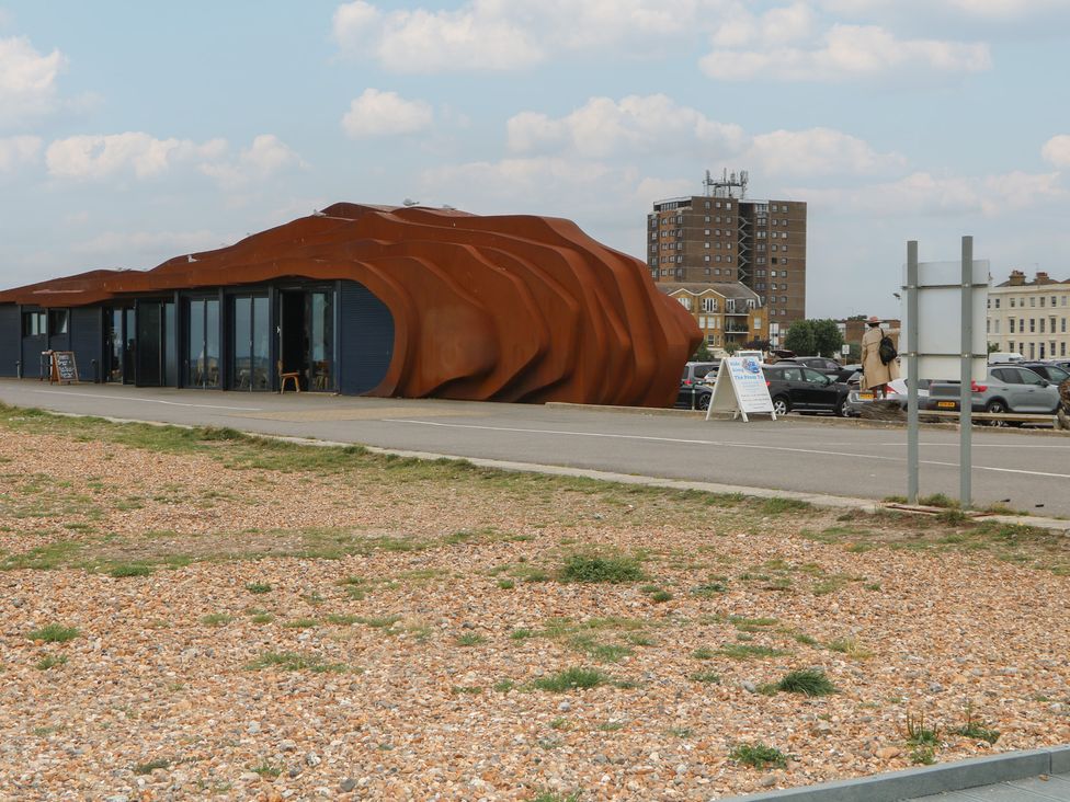 A building near a parking lot at Lower Floor Flat in 