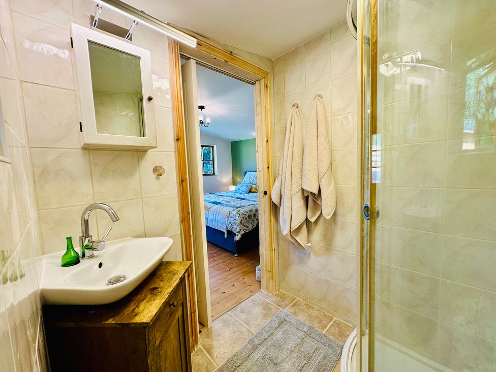 A bathroom with a sink and shower at Harvey's Lodge in Helston