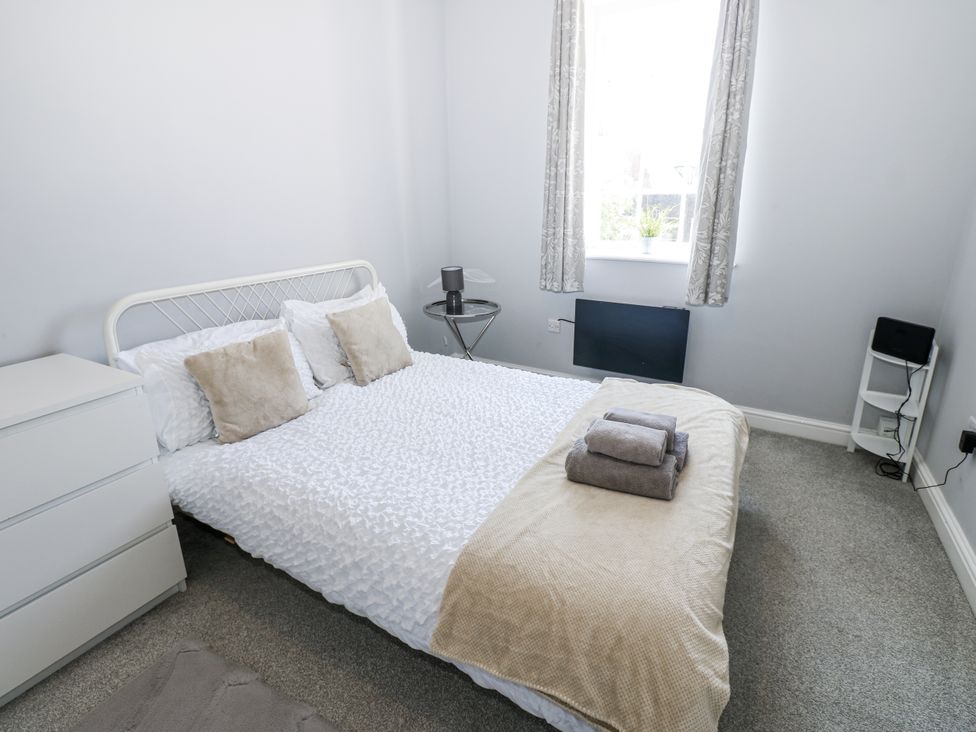 A bedroom with bed and nightstand at Lowther House in Whitehaven