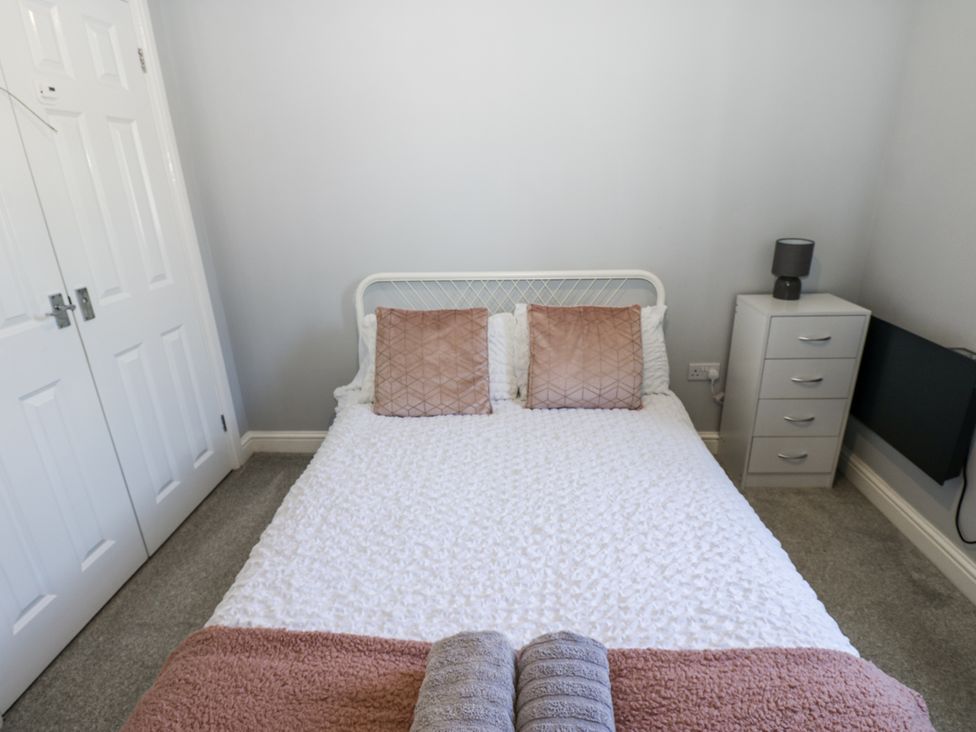 A bedroom with a bed and bedside lamp at Lowther House in Whitehaven