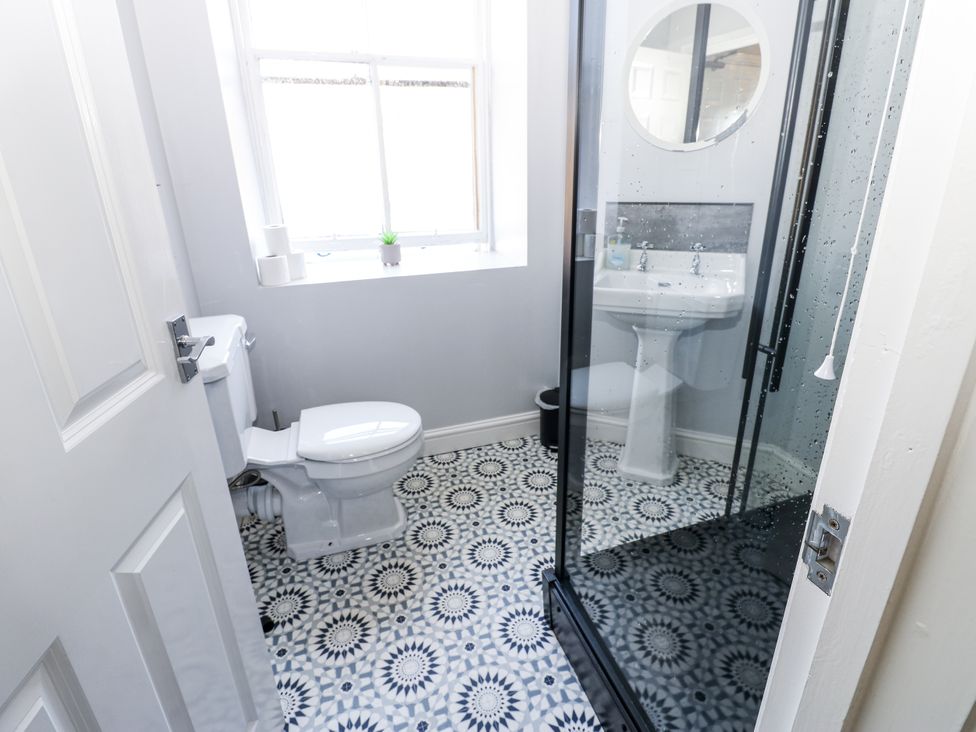 A bathroom with a shower and sink at Lowther House in Whitehaven