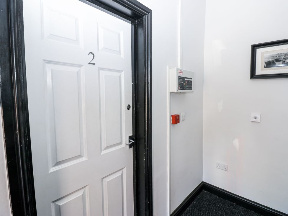 A door with the number 2 and a fire alarm at Lowther House Whitehaven