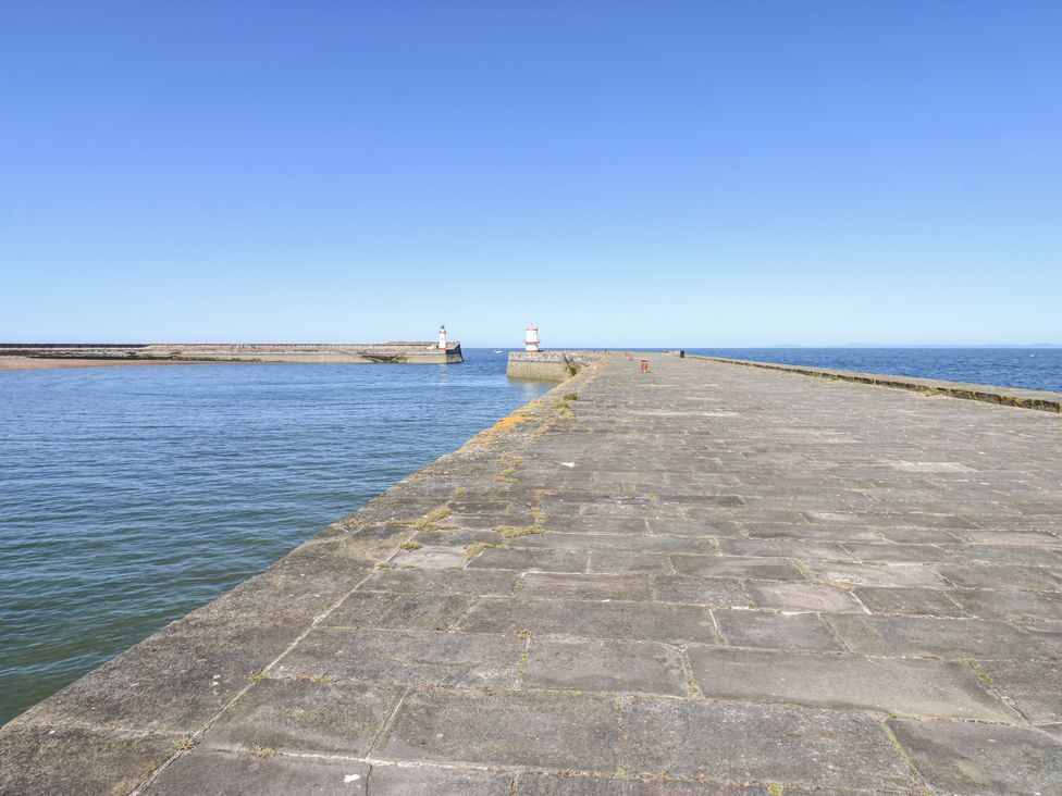 A pier extending into the water with lighthouses at Lowther House in Whitehaven