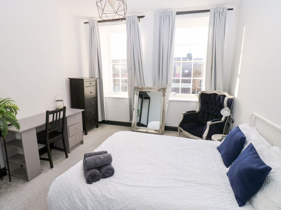 A bedroom with a bed and desk at Lowther Apartment in Whitehaven