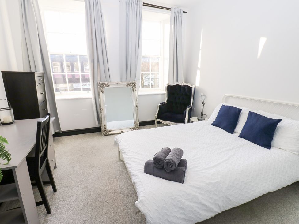 A bedroom with a bed and desk at Lowther Apartment in Whitehaven