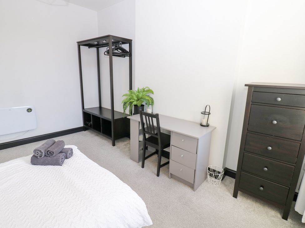 A bedroom with a bed and desk at Lowther Apartment in Whitehaven