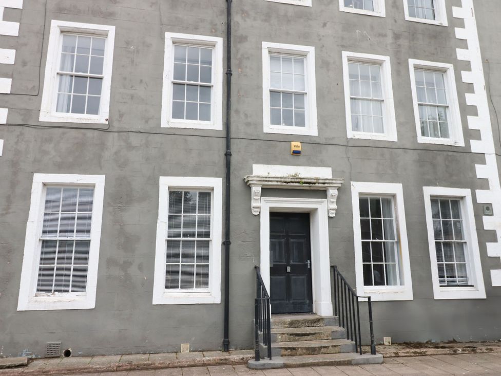 A building facade with windows and entrance steps at Lowther Penthouse in Whitehaven