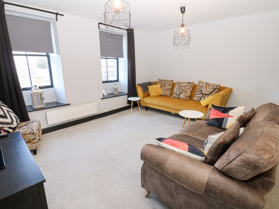 A living room with a sofa and table at Lowther Penthouse in Whitehaven