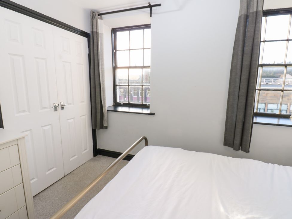 A bedroom with a bed and wardrobe at Lowther Penthouse in Whitehaven