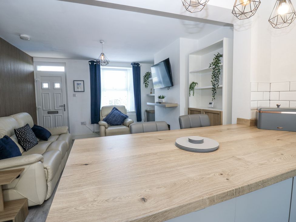 A living room with a sofa and television at Keekle Terrace in Cleator Moor