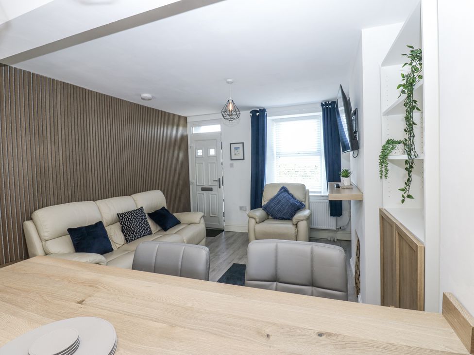 A living room with a sofa and television at Keekle Terrace in Cleator Moor