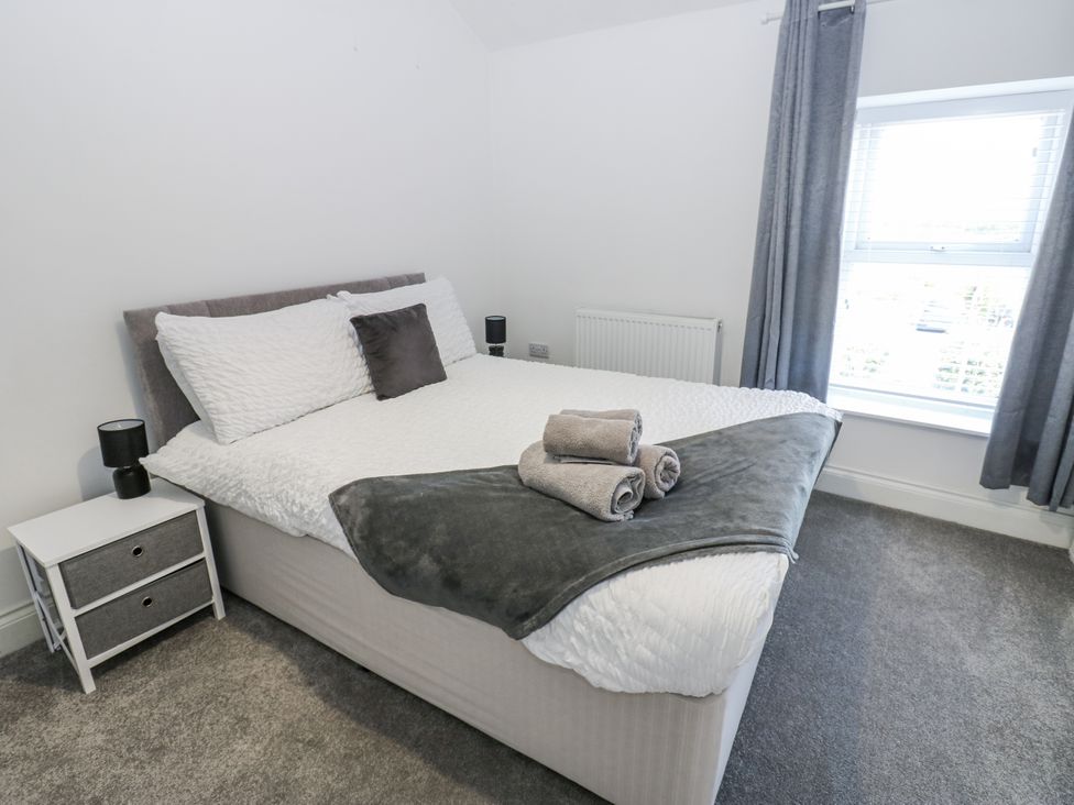 A bedroom with a bed and a bedside table at Keekle Terrace in Cleator Moor