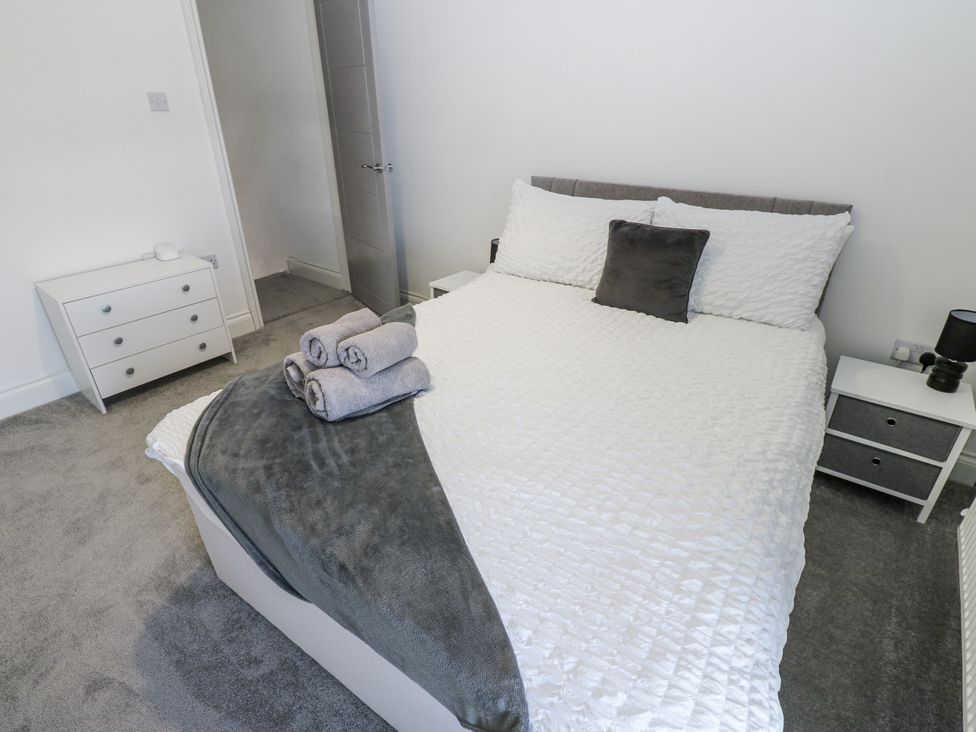 A bedroom with a bed and bedside tables at Keekle Terrace in Cleator Moor