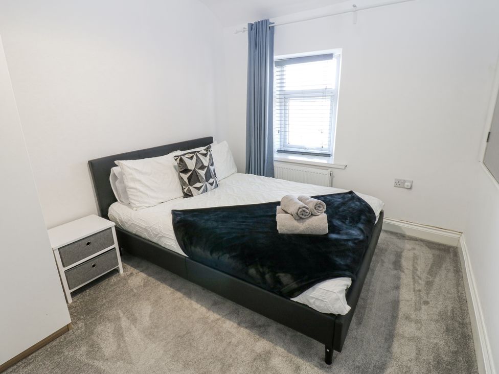 A bedroom with a bed and bedside table at Keekle Terrace in Cleator Moor