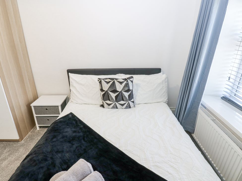A bedroom with a bed and bedside table at Keekle Terrace Cleator Moor