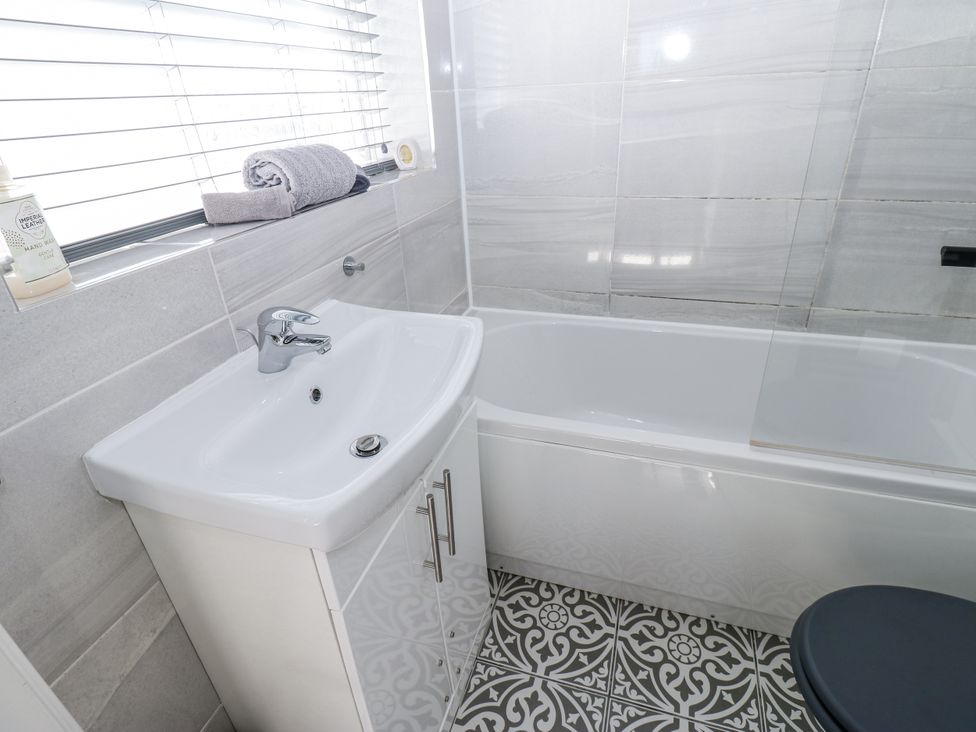 A bathroom featuring a sink and bathtub at Keekle Terrace in Cleator Moor