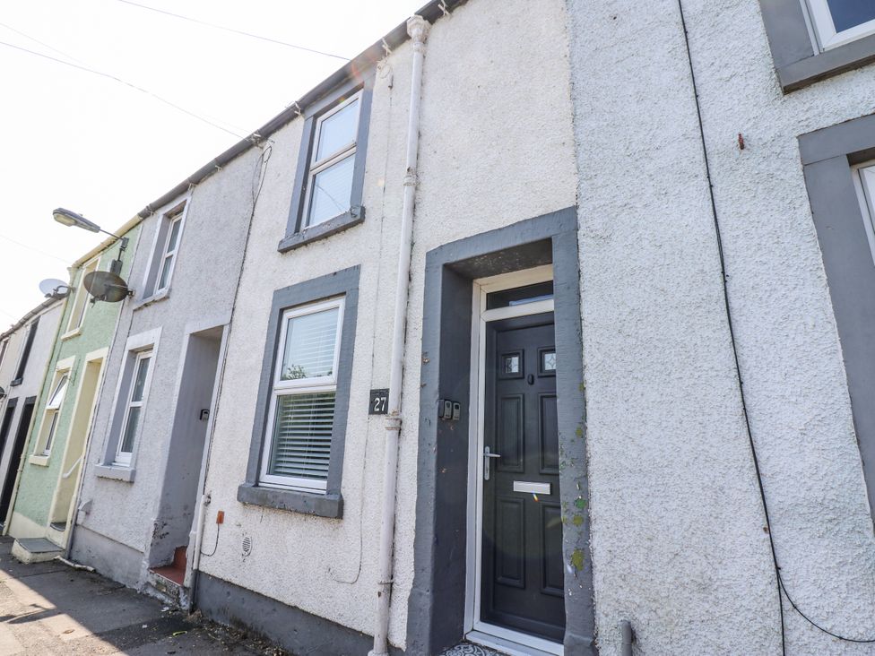An exterior view of a house with a door and windows at Keekle Terrace in Cleator Moor