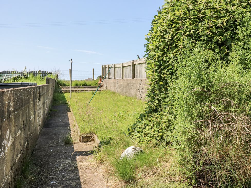 A garden with a path and fence at Keekle Terrace in Cleator Moor